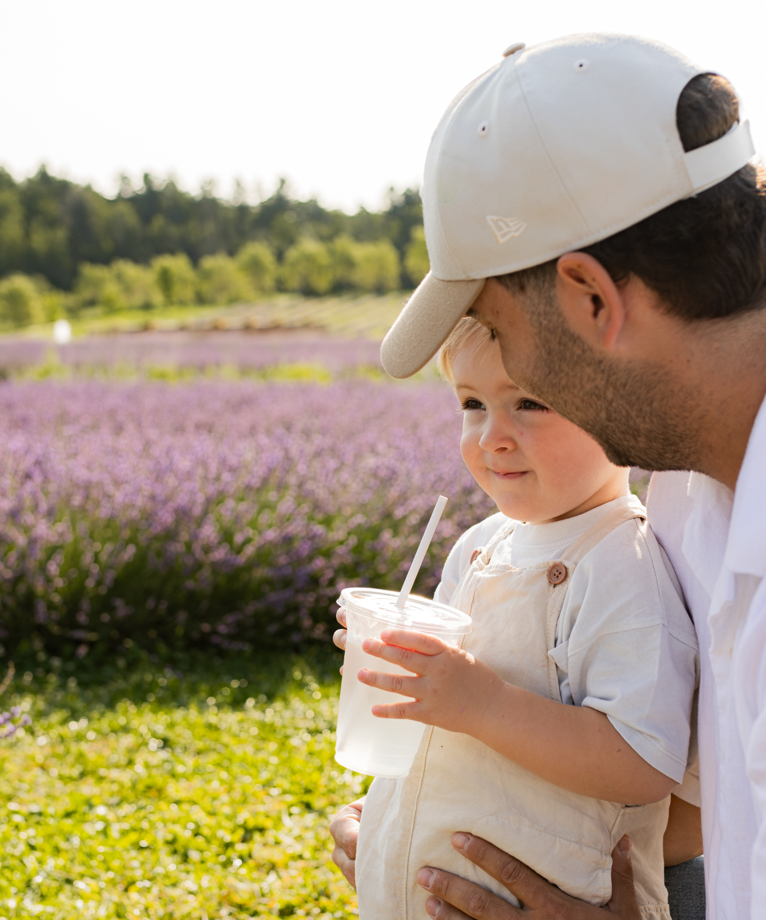 Père et enfant avec limonade à la lavande dans les champs